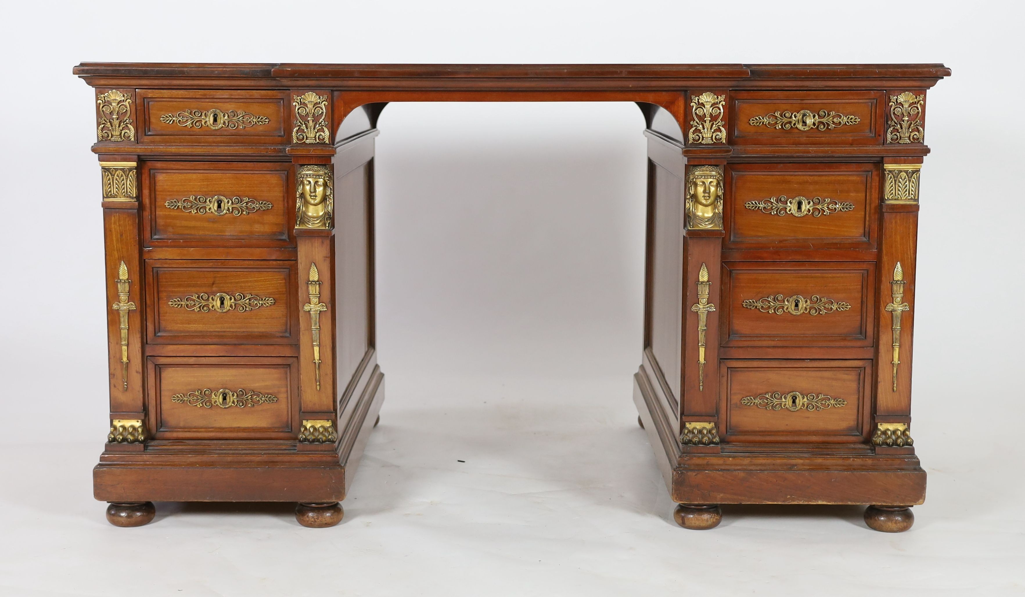 An early 20th century French classical revival mahogany breakfront pedestal desk, W.135cm D.82cm H.75cm